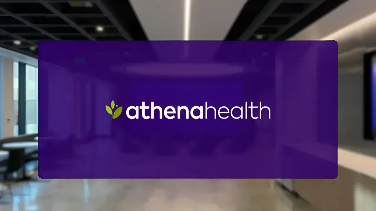 athenahealth logo with white text and green leaf icon on a purple overlay with a blurred office background.