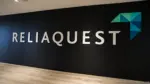ReliaQuest logo & name on dark wall. Off Campus Drive 2026: Associate Software Engineer for freshers.