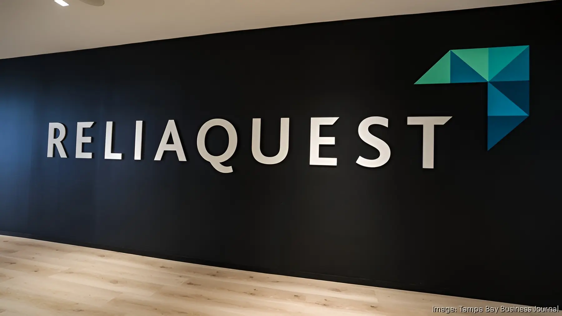 ReliaQuest logo & name on dark wall. Off Campus Drive 2026: Associate Software Engineer for freshers.