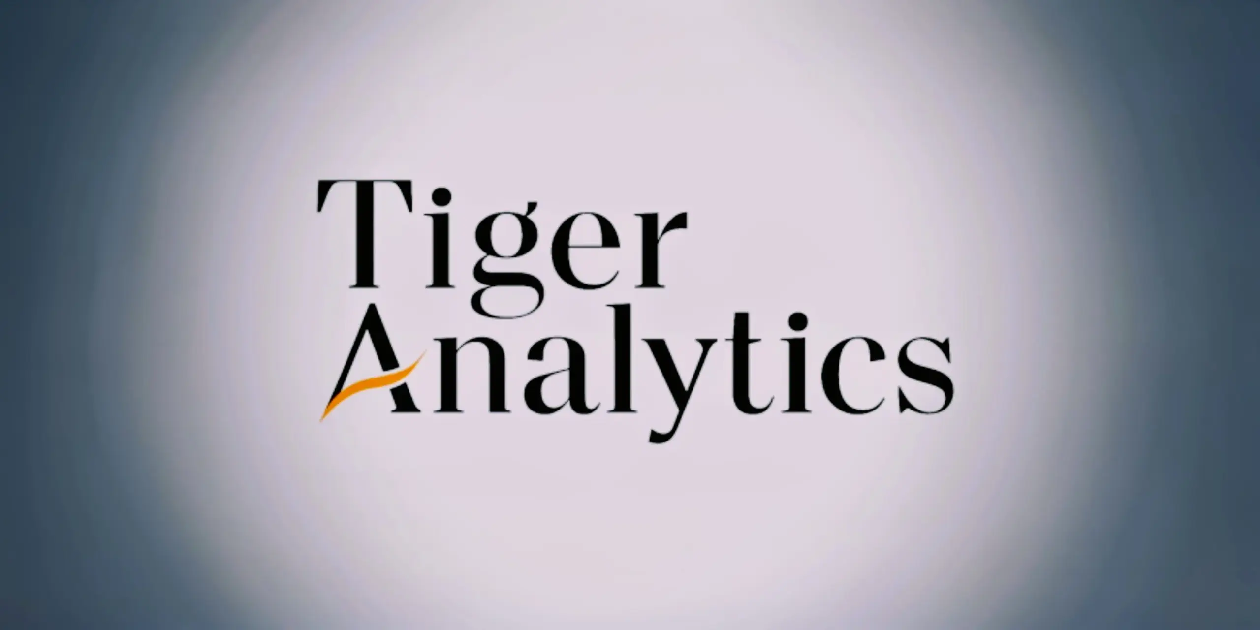 Tiger Analytics logo with black text and an orange swoosh under the 'A'.